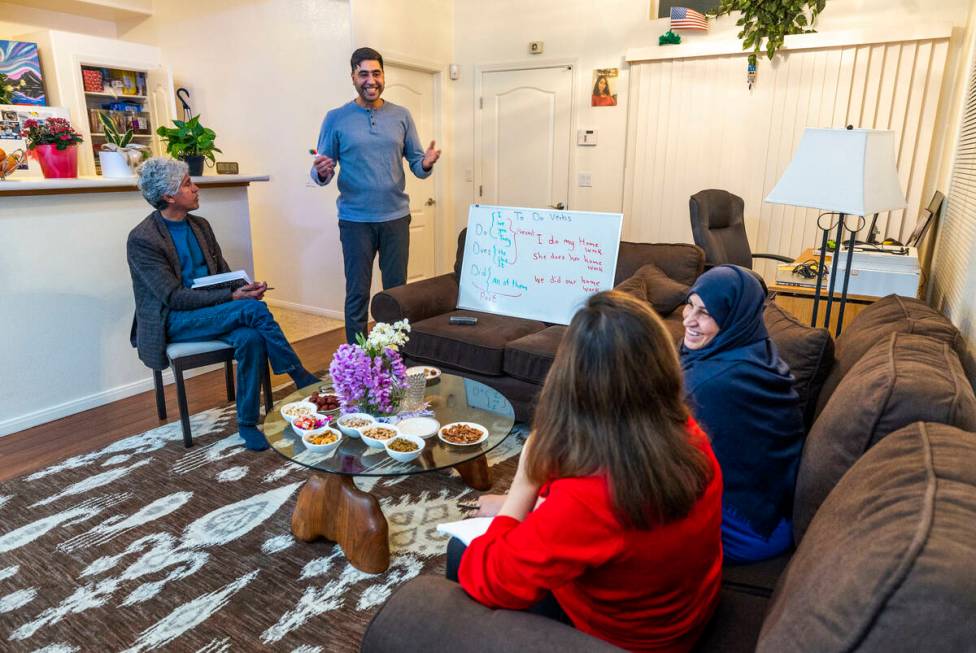 Abdul looks to son Mohammad "Benny" Shirzad as he teaches English to his wife, Shabana and moth ...