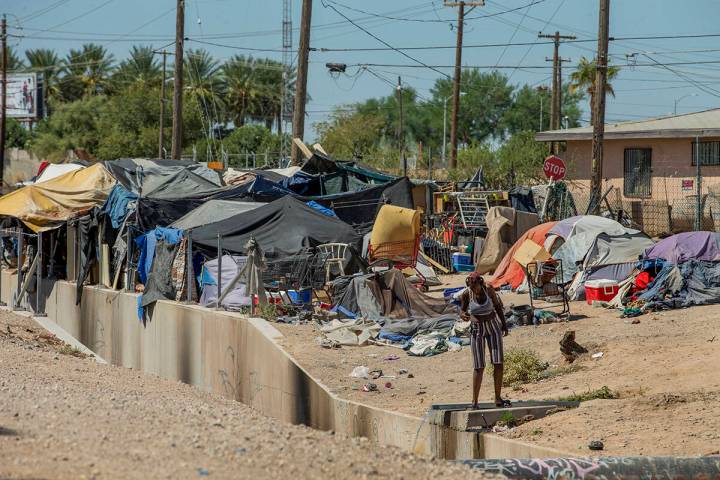 Homeless people begin their day as members of Food Not Bombs and the Sidewalk Project work to c ...