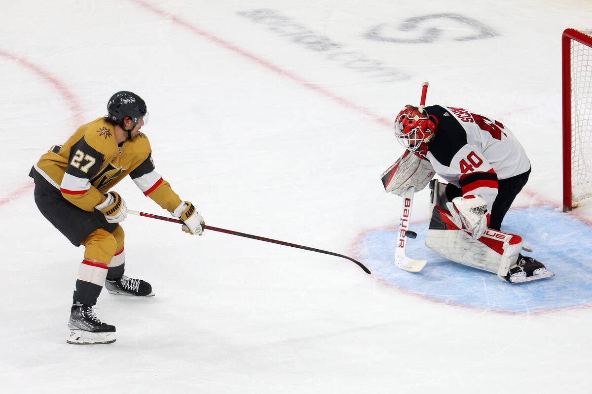 Vegas Golden Knights defenseman Shea Theodore (27) shoots the puck for a score against New Jers ...