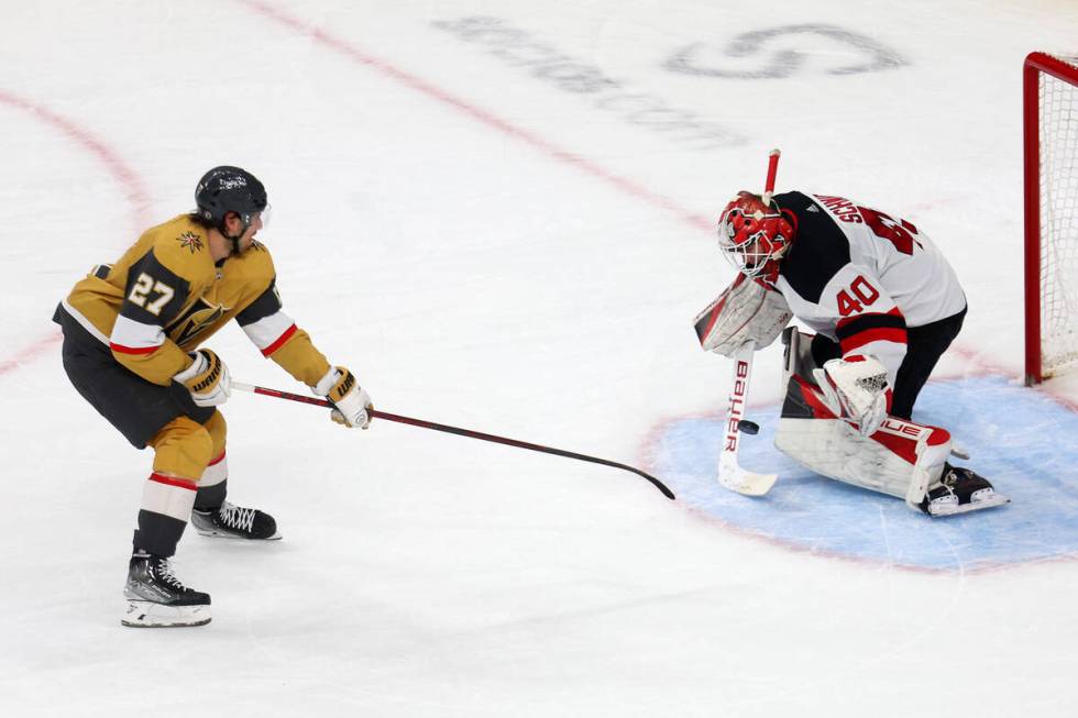 Vegas Golden Knights defenseman Shea Theodore (27) shoots the puck for a score against New Jers ...