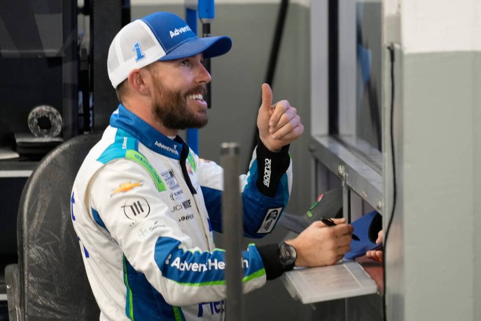 Ross Chastain talks to a fan while signing autographs after a practice for the NASCAR Daytona 5 ...