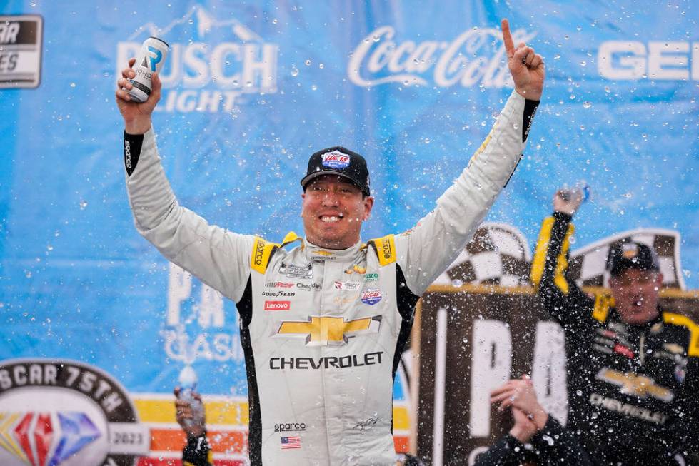 Kyle Busch celebrates after winning a NASCAR Cup Series auto race at Auto Club Speedway in Font ...