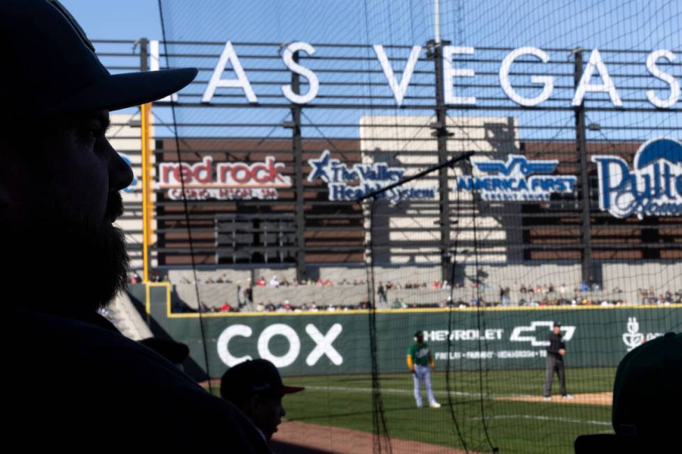 Fans watch an MLB exhibition game between the Oakland Athletics and the Cincinnati Reds at the ...