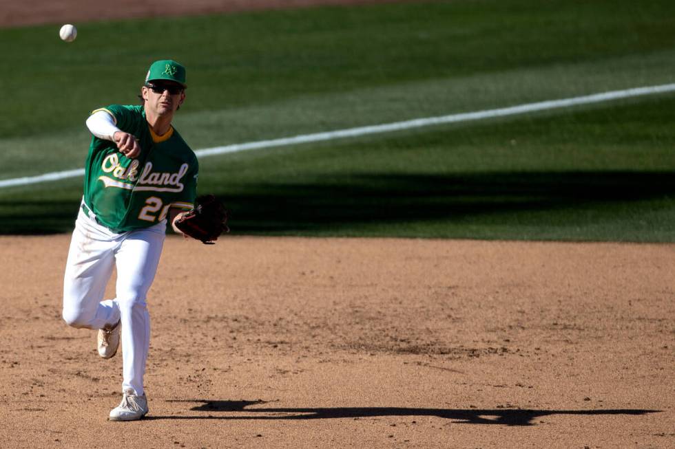 Oakland Athletics third baseman Jonah Bride throws to first base in an attempt to out the Cinci ...