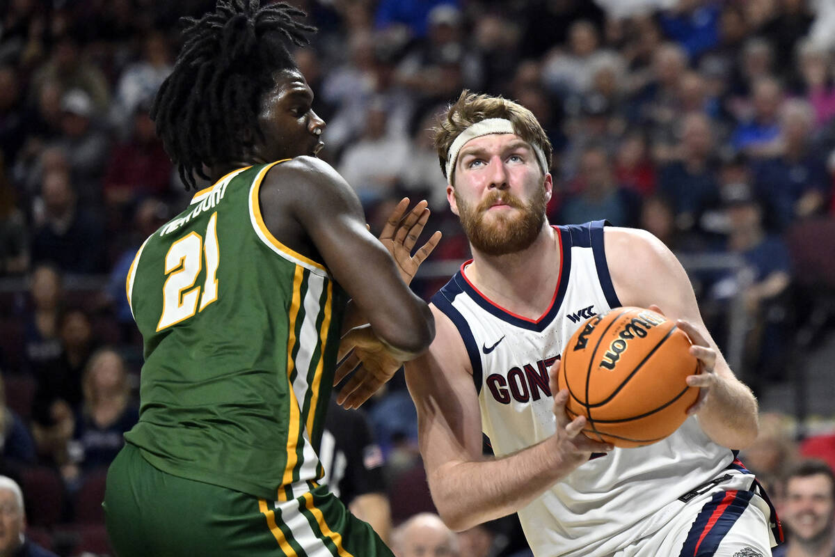 Gonzaga forward Drew Timme, right, drives to there basket against San Francisco forward Ndewedo ...