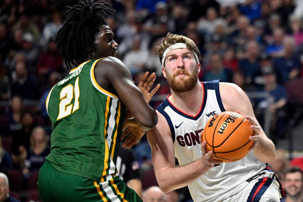 Gonzaga forward Drew Timme, right, drives to there basket against San Francisco forward Ndewedo ...