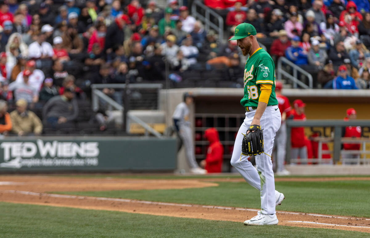 Oakland Athletics starting pitcher Paul Blackburn (58) walks back to the dugout after being rel ...