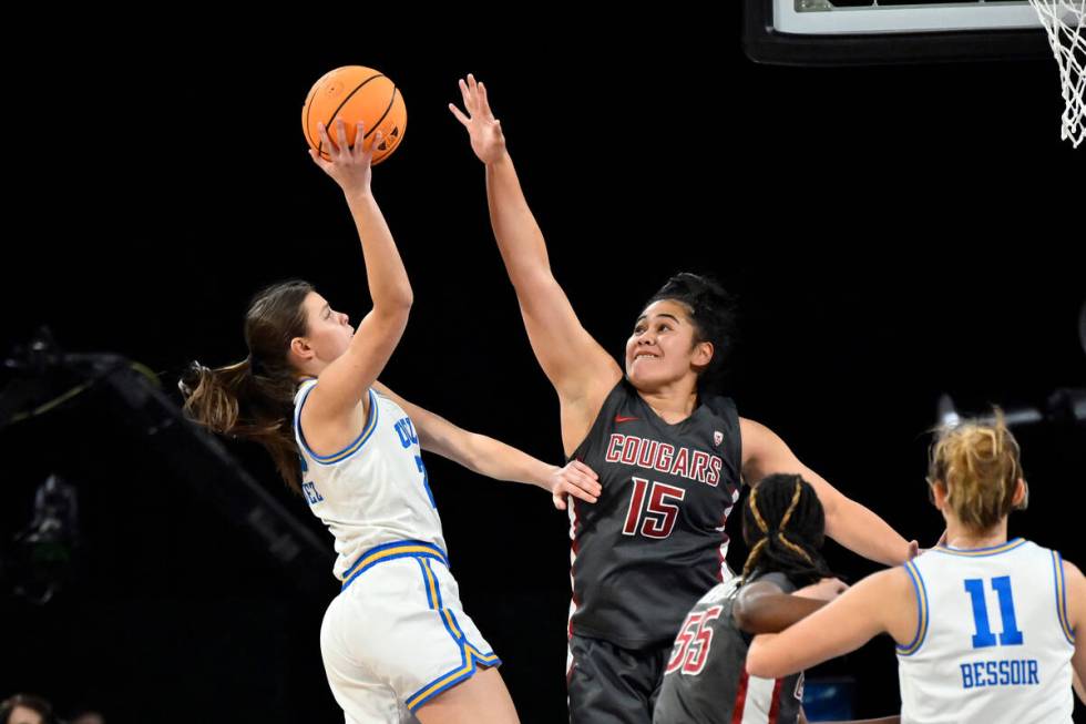 UCLA forward Gabriela Jaquez, left, shoots against Washington State forward Ula Motuga (15) dur ...