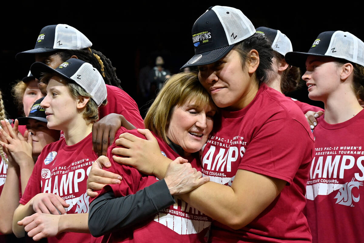 Washington State head coach Kamie Ethridge, center, is hugged by Ula Motuga as the team celebra ...