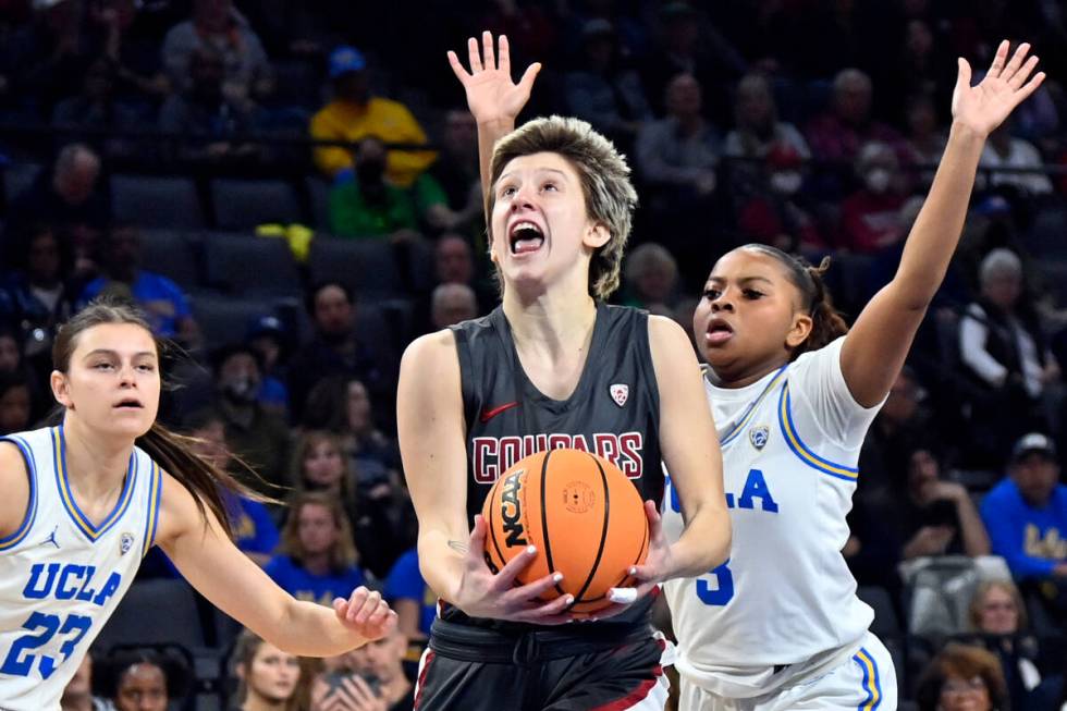 Washington State guard Astera Tuhina, center, drives with the ball against UCLA during the firs ...