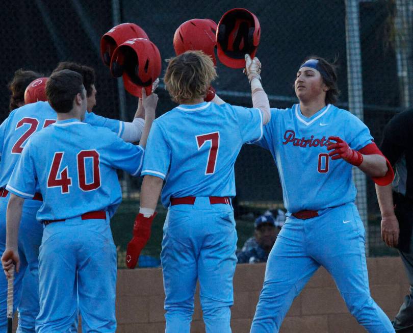 Liberty’s Casey Kapushy (0) celebrates with his teammates after hitting a two-run homeru ...