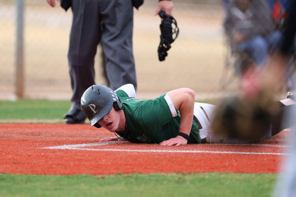 Palo Verde's Andrew Kaplan (19) slides home for a run against Legacy during a baseball game at ...