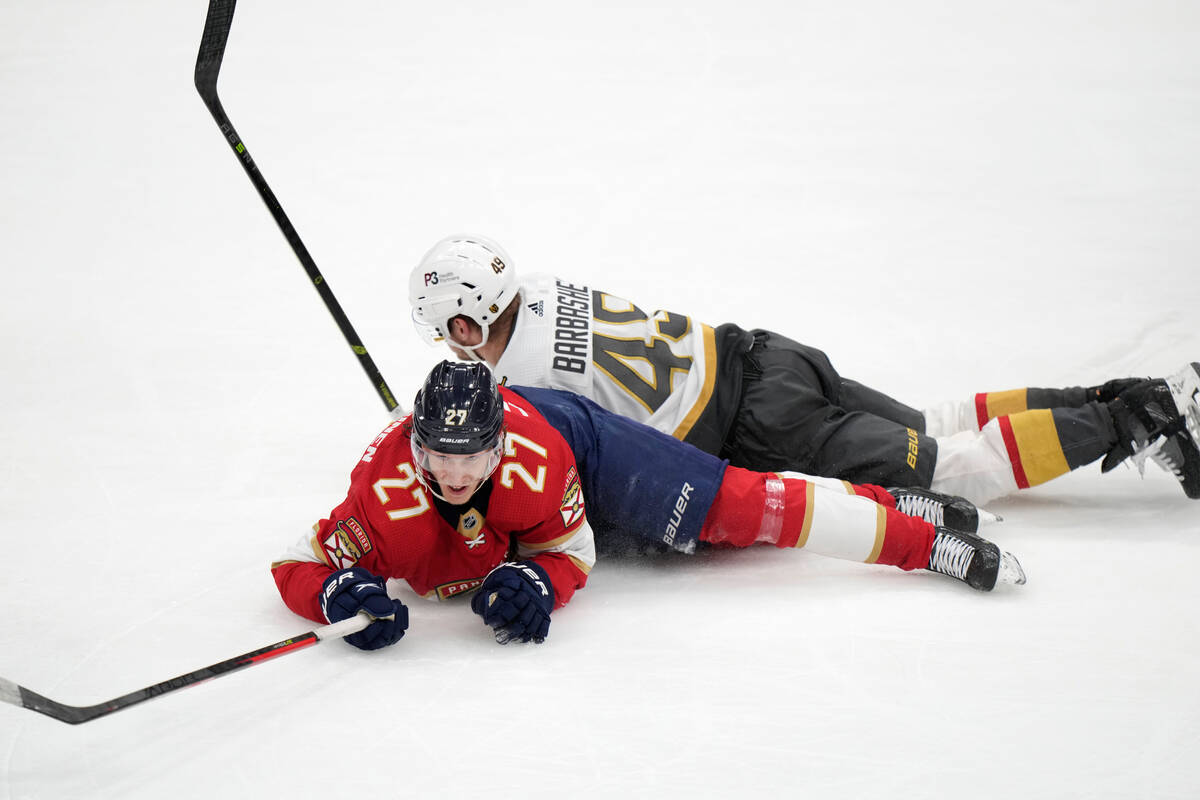 Florida Panthers center Eetu Luostarinen (27) and Vegas Golden Knights center Ivan Barbashev (4 ...