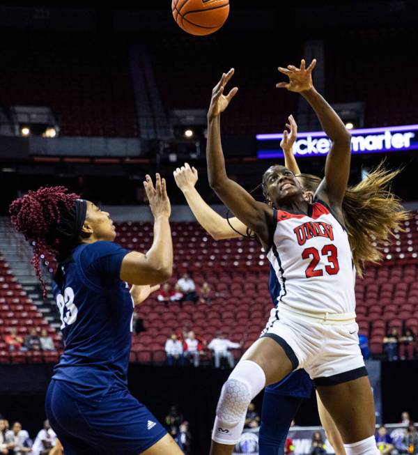 UNLV Lady Rebels center Desi-Rae Young (23) goes for a rebound against Nevada Wolf Pack forward ...