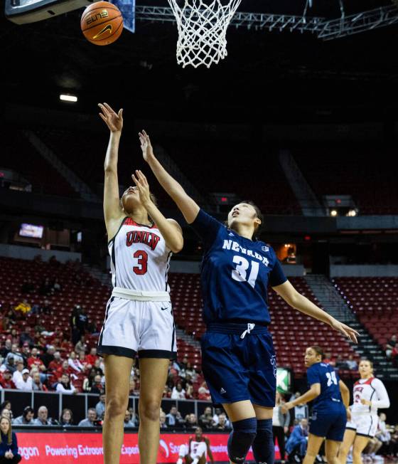 UNLV Lady Rebels guard Kiara Jackson (3) shoots over drives past Nevada Wolf Pack guard Tiffan ...