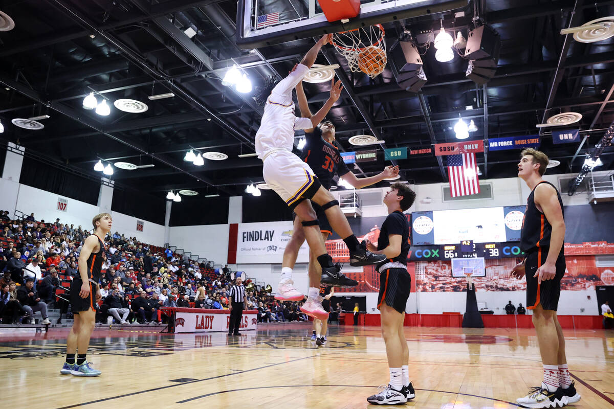 Durango's Michael Bartlett (22) dunks the ball over Douglas' Reese Torres (33) during a boys cl ...