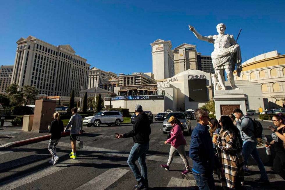 Pedestrians walk along the Strip outside Caesars Palace on Jan. 26, 2023, in Las Vegas. (Chase ...