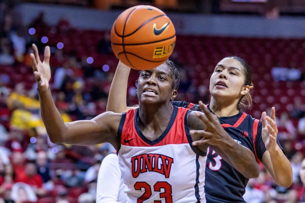 UNLV center Desi-Rae Young (23) looks to grab a loose ball with San Diego State forward Kim Vil ...