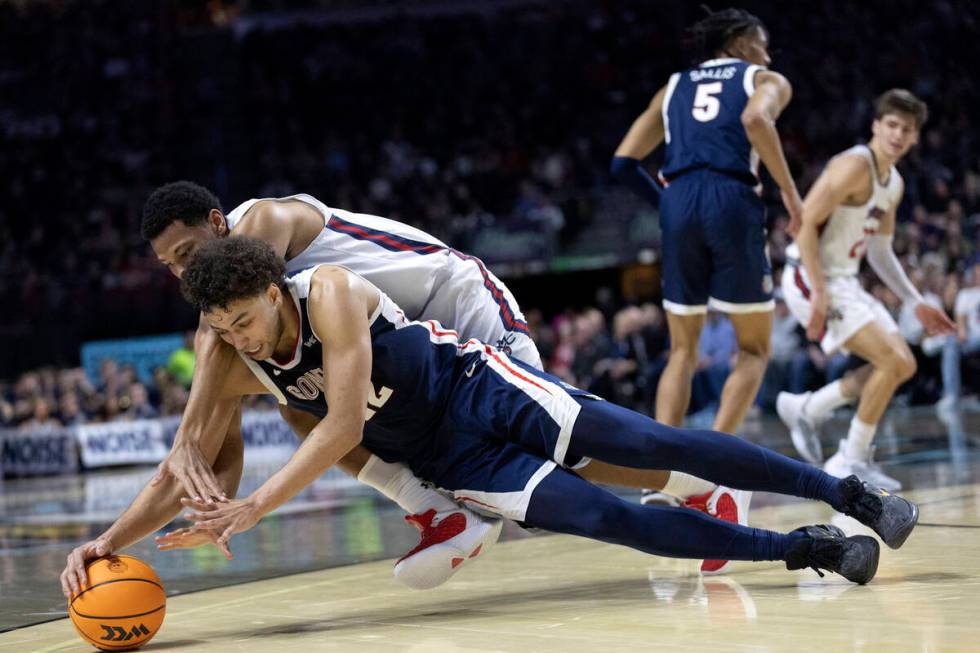 Gonzaga Bulldogs forward Anton Watson (22) dives for the ball to steal possession from St. Mary ...