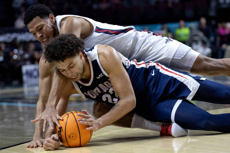 Gonzaga Bulldogs forward Anton Watson (22) dives for the ball to steal possession from St. Mary ...