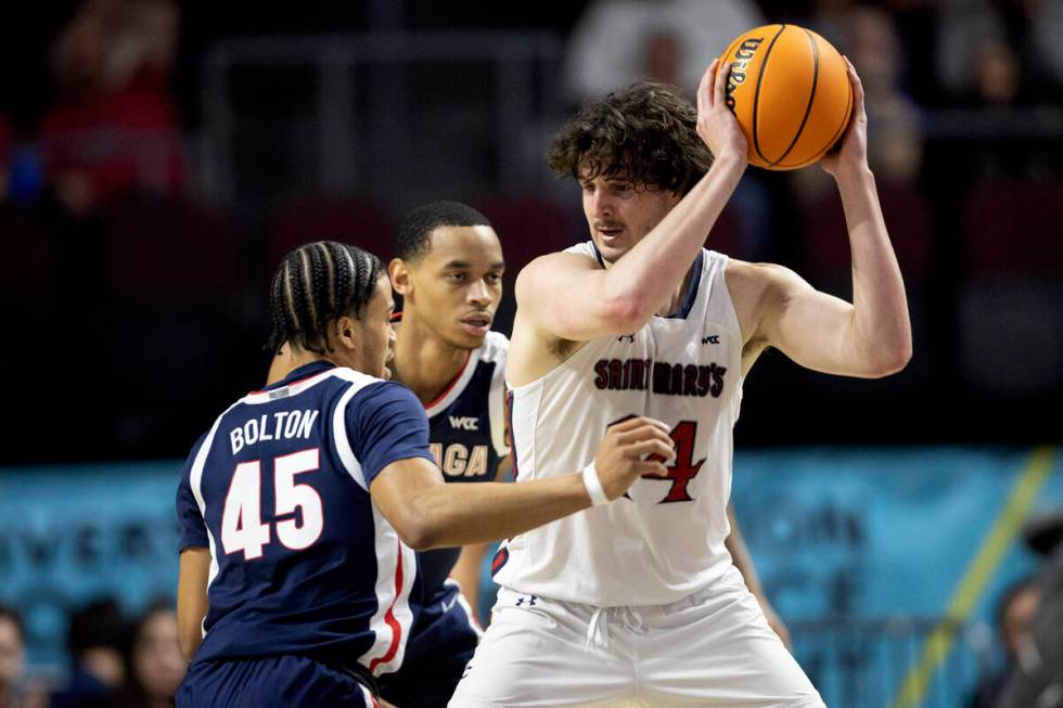 St. Mary's Gaels forward Kyle Bowen (14) looks to pass while Gonzaga Bulldogs guard Rasir Bolto ...