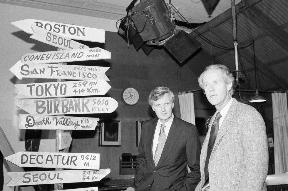 Actors from the television series M*A*S*H*, Alan Alda, left, and Mike Farrell look at part of a ...