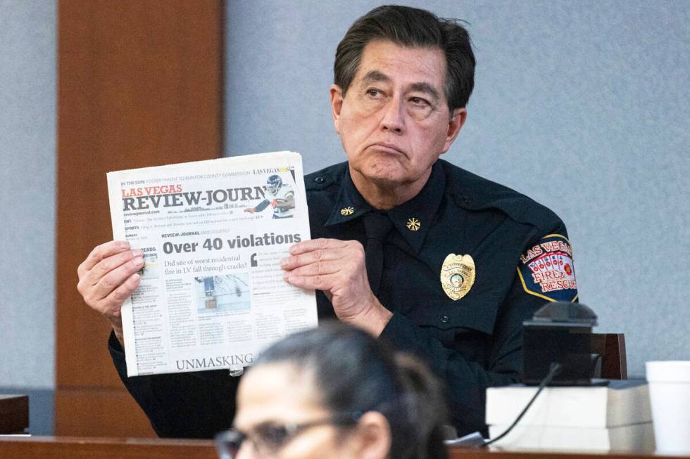 Las Vegas Fire Marshal Robert Nolan, holds a copy of the Las Vegas Review-Journal as he deliver ...
