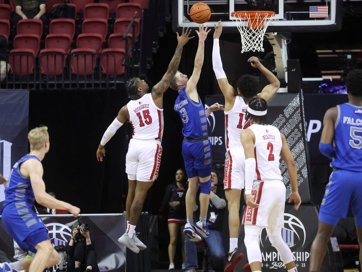 Air Force guard Jake Heidbreder (3) lays up the ball between UNLV guard Luis Rodriguez (15) and ...