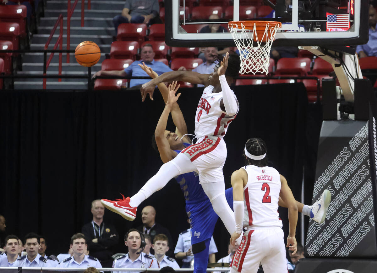 UNLV forward Victor Iwuakor (0) blocks the shot of Air Force forward Nikc Jackson (22) during t ...