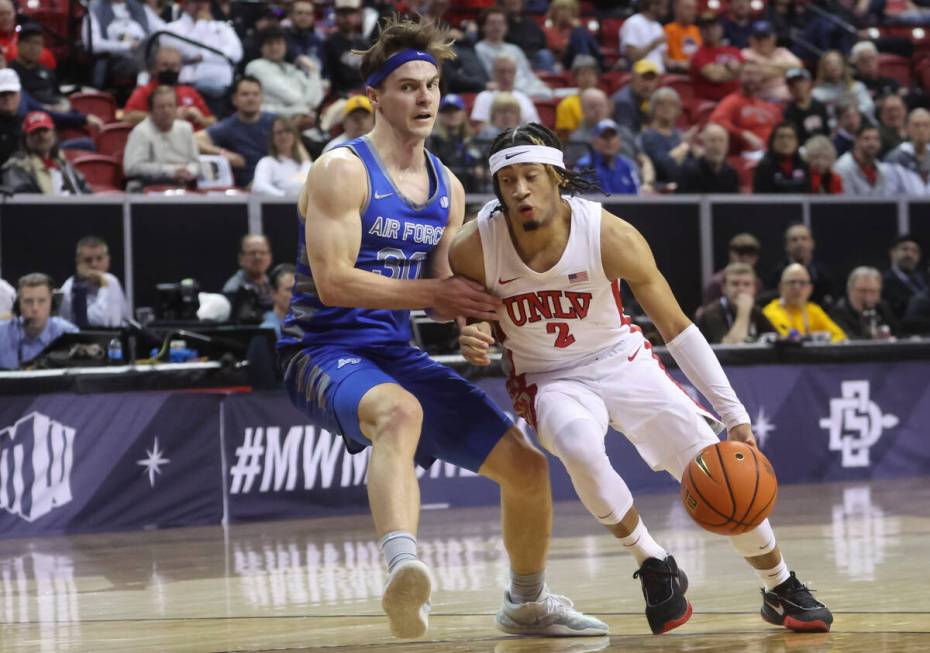 UNLV guard Justin Webster (2) drives the ball against Air Force guard Camden Vander Zwaag (30) ...