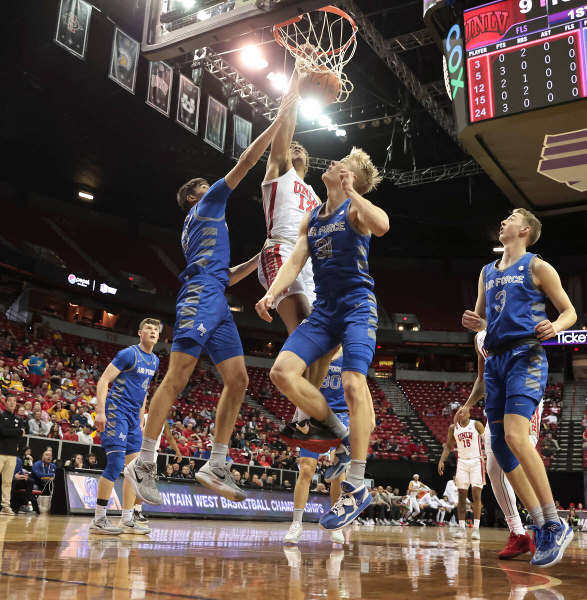 UNLV center David Muoka (12) dunks the ball between Air Force forwards Beau Becker (14) and Ryt ...