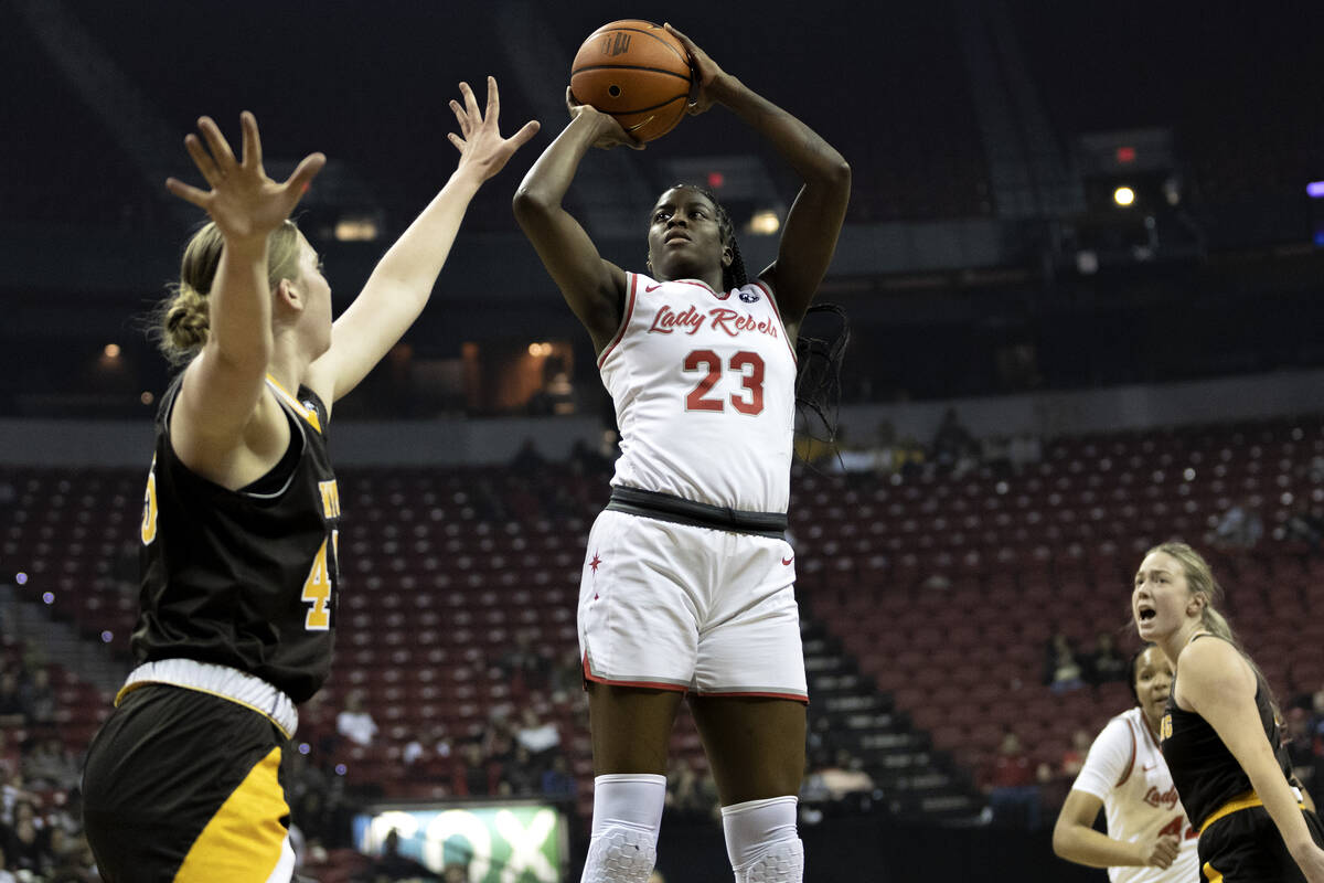 UNLV Lady Rebels center Desi-Rae Young (23) shoots against Wyoming Cowgirls center Allyson Fert ...