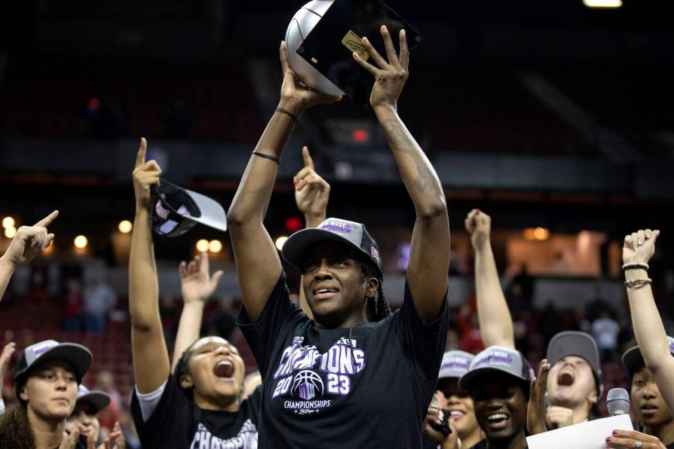 UNLV Lady Rebels center Desi-Rae Young holds up her tournament MVP trophy as her team erupts in ...