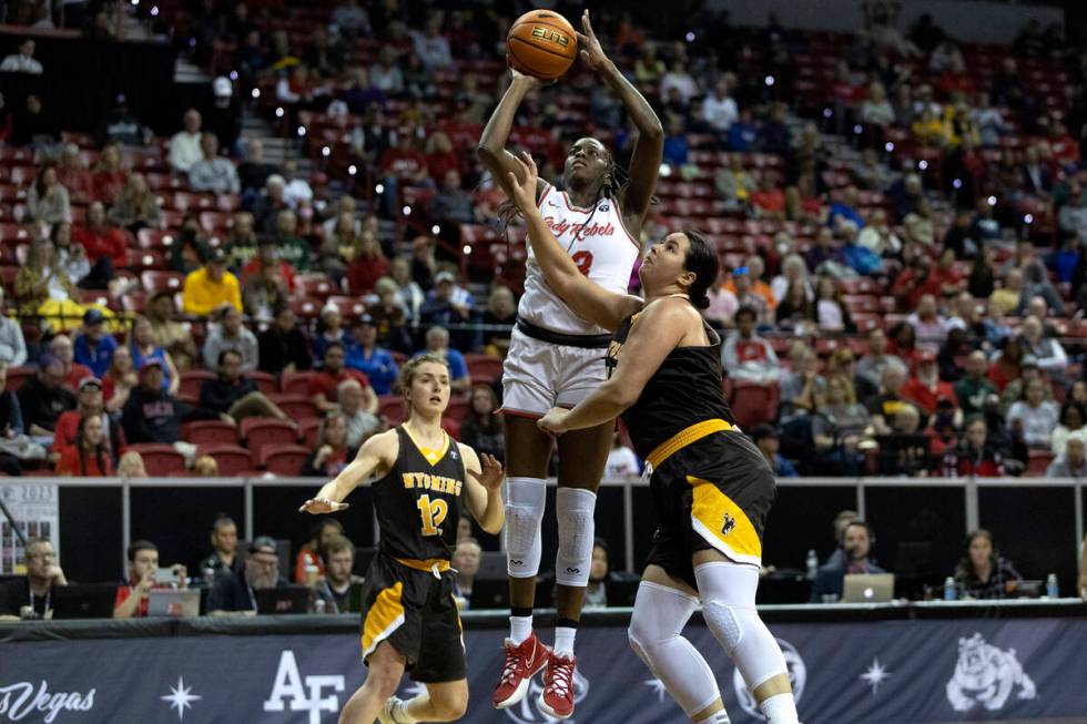 UNLV Lady Rebels center Desi-Rae Young (23) shoots against Wyoming Cowgirls guard Malene Peders ...