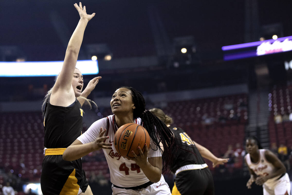 UNLV Lady Rebels forward Alyssa Brown (44) drives to shoot around Wyoming Cowgirls forward Grac ...