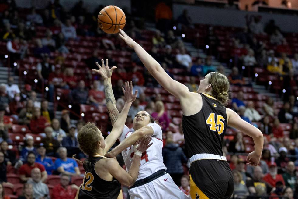 UNLV Lady Rebels guard Essence Booker (24) falls back while shooting against Wyoming Cowgirls g ...