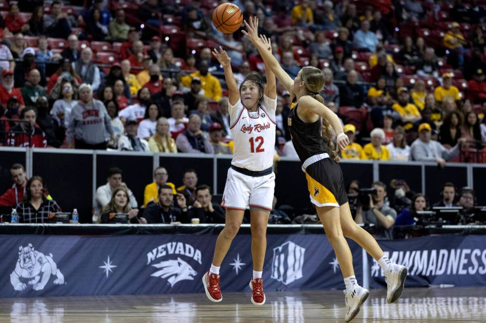 UNLV Lady Rebels guard Alyssa Durazo-Frescas (12) shoots against Wyoming Cowgirls guard Emily M ...