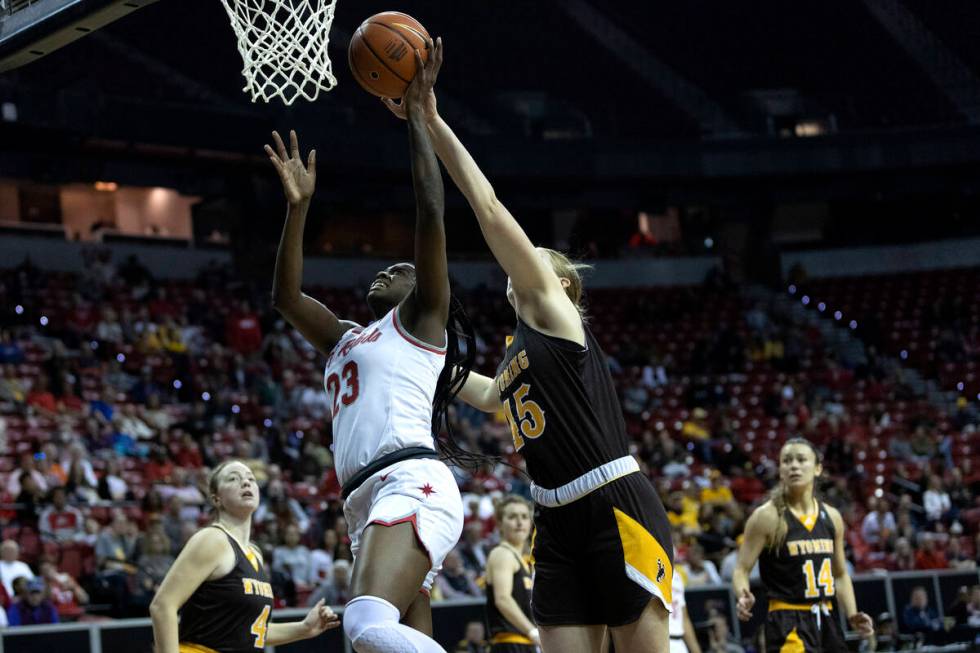 UNLV Lady Rebels center Desi-Rae Young (23) shoots against Wyoming Cowgirls center Allyson Fert ...