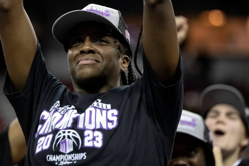 UNLV Lady Rebels center Desi-Rae Young holds up her tournament MVP trophy as her team erupts in ...