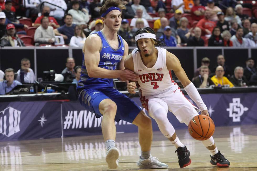 UNLV guard Justin Webster (2) drives the ball against Air Force guard Camden Vander Zwaag (30) ...