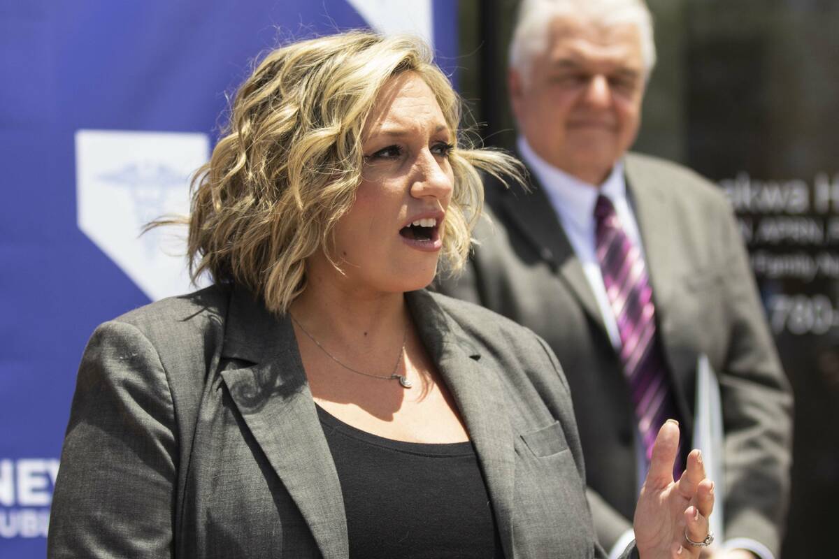 State Majority Leader Nicole Cannizzaro speaks as Gov. Steve Sisolak looks on, on Wednesday, Ju ...