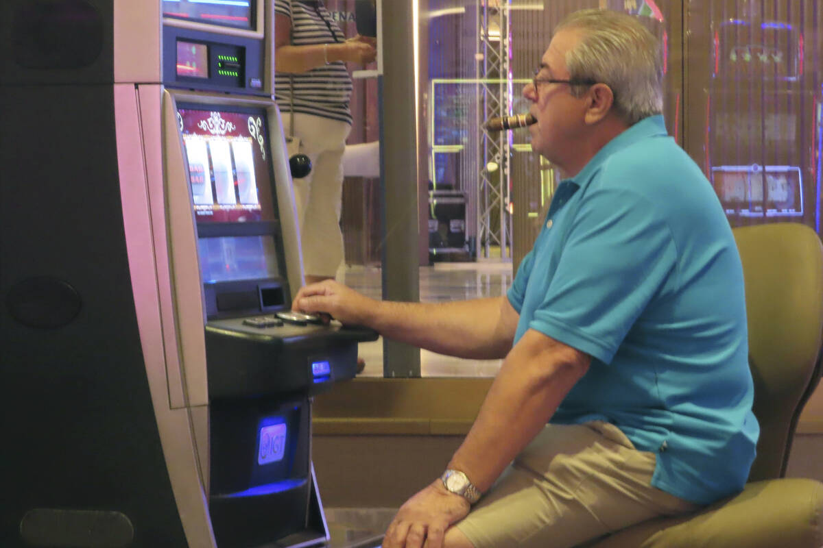 A gambler plays a slot machine while smoking in the Hard Rock casino in Atlantic City N.J. on A ...