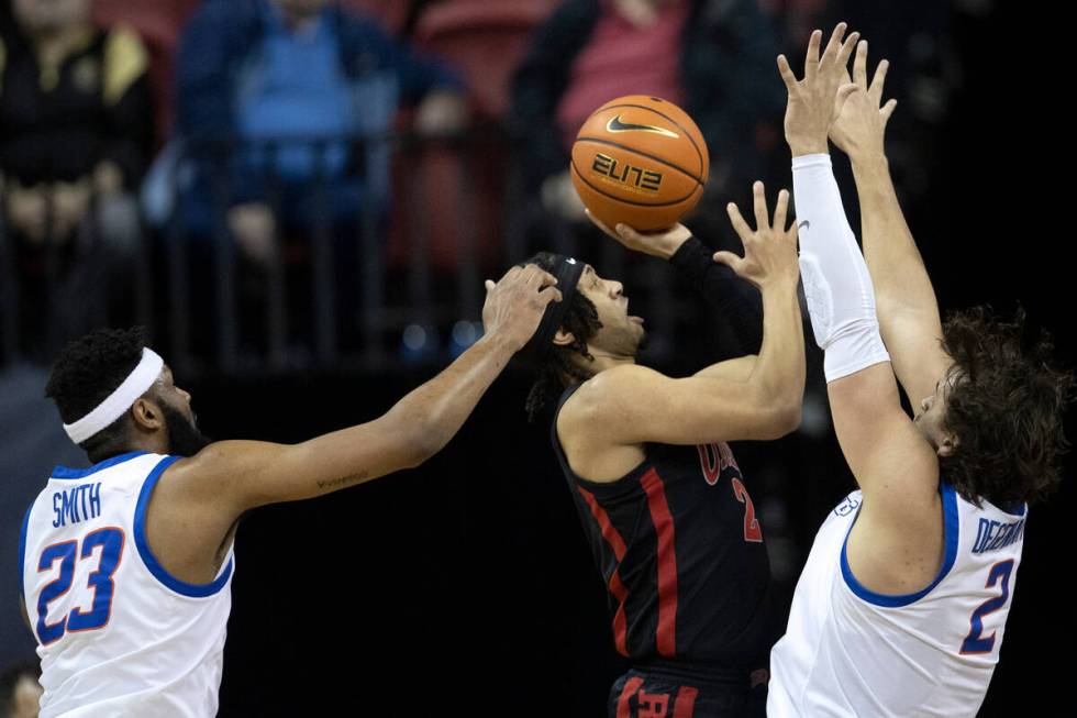 UNLV Rebels guard Justin Webster, center, shoots against Boise State Broncos forward Naje Smith ...