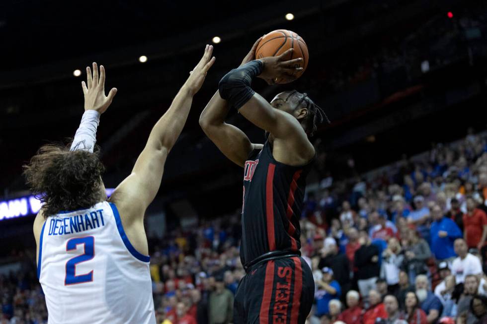 UNLV Rebels guard Shane Nowell (3) shoots a three-pointer against Boise State Broncos forward T ...