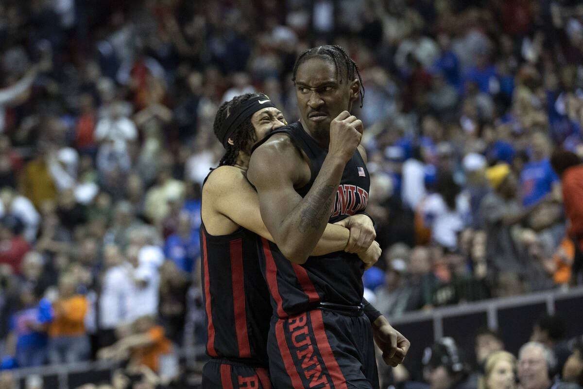 UNLV Rebels guard Justin Webster, left, hugs guard Shane Nowell after Nowell scored a game-tyin ...