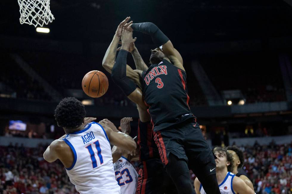 UNLV Rebels guard Shane Nowell (3) and center David Muoka, back center, jump for a rebound agai ...