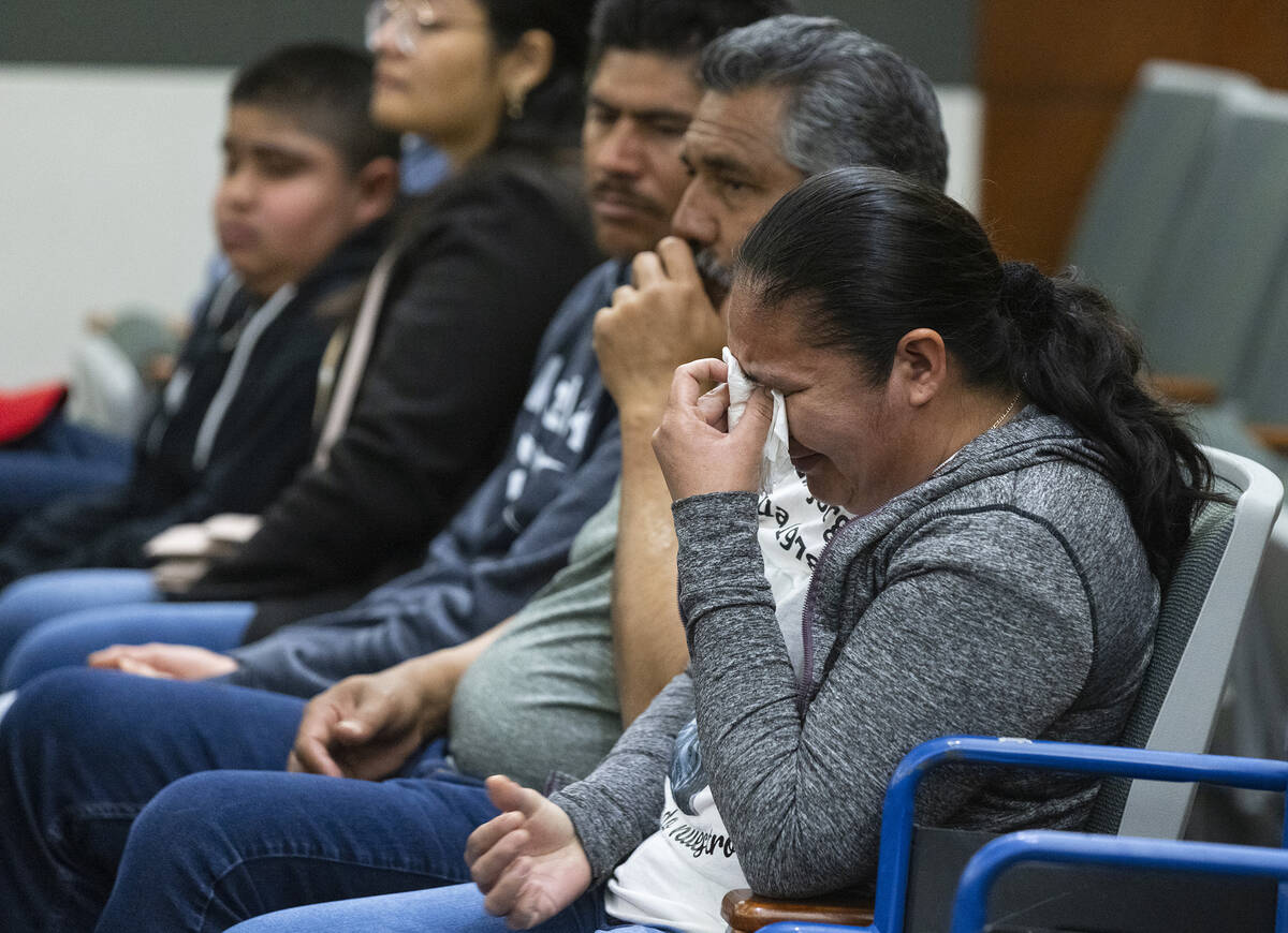 Estorgia Godoy, the sister of shooting victim Jorge Godoy-Lua, 43, weeps as a member of the fam ...