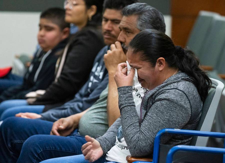 Estorgia Godoy, the sister of shooting victim Jorge Godoy-Lua, 43, weeps as a member of the fam ...