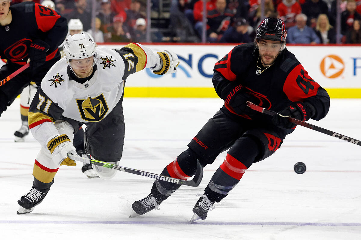 Vegas Golden Knights' William Karlsson (71) chips the puck past Carolina Hurricanes' Shayne Gos ...