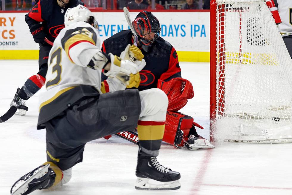 Vegas Golden Knights' Paul Cotter (43) shoots the puck past Carolina Hurricanes goaltender Fred ...